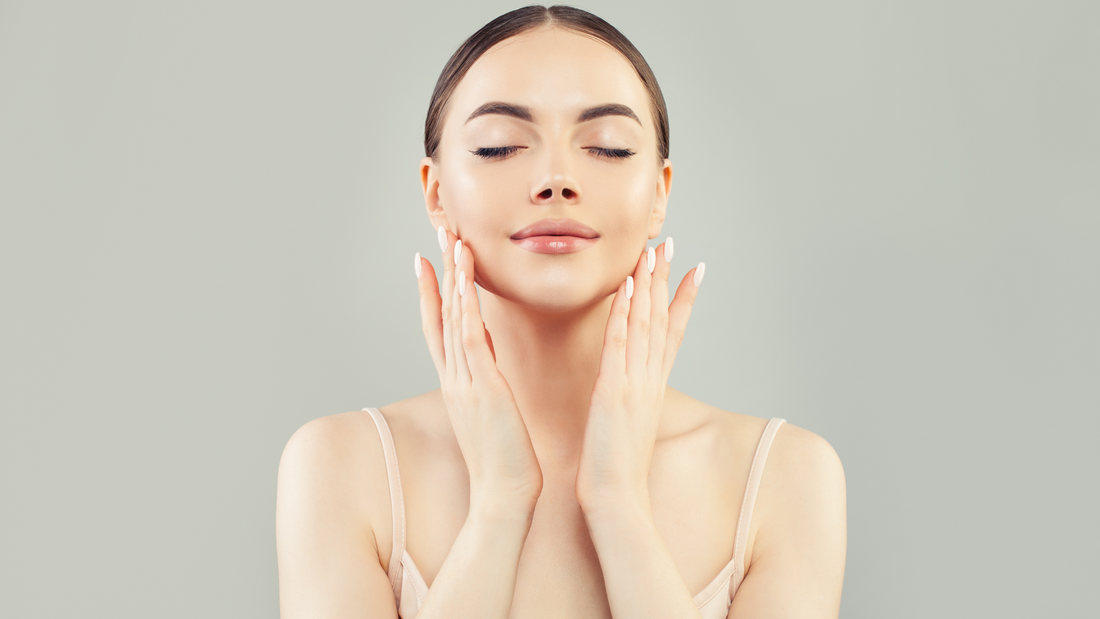 Young woman with flawless skin touching her face, showcasing skincare beauty and wellness